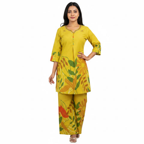 Woman wearing a yellow floral outfit taking a mirror selfie.