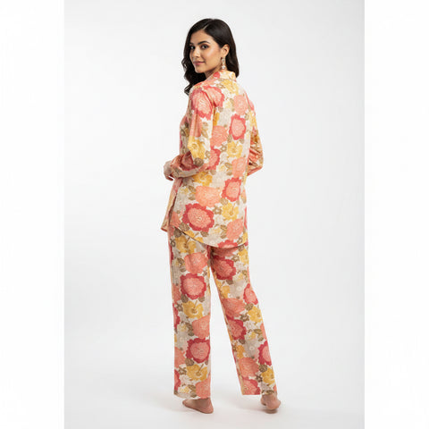 Mannequin wearing a floral outfit in a room with a door and wall.