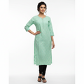Green kurta hanging on a rack with colorful clothes in the background